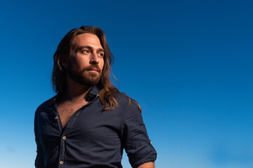 Modern version of Jesus christ looking aside during sunset