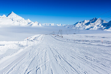 Fototapeta na wymiar Winter mountains, panorama - snowcapped peaks of the Italian Alps and ski slopes