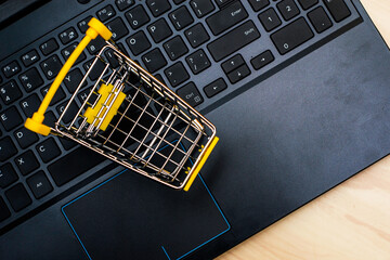 shopping cart on laptop keyboard concept of online trading cyber monday