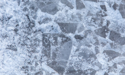 Crushed ice in a puddle as an abstract background.