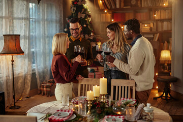 Group of friends at Christmas party together indoors