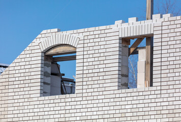 A window in a brick house under construction.