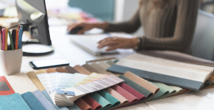 Designer working with her computer in her studio
