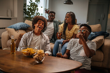Friends drinking beer and having fun in the living room