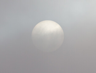 White sun in fog clouds.