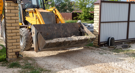 The tractor is working with rubble on the road.