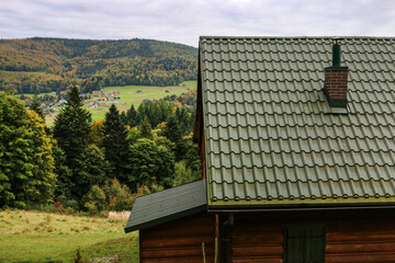 The green roof of an old wooden house made of sheet metal.