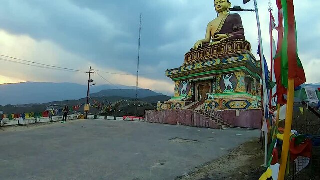 huge buddha golden statue from different perspective with dramatic sky at evening video is taken at giant buddha statue tawang arunachal pradesh india.