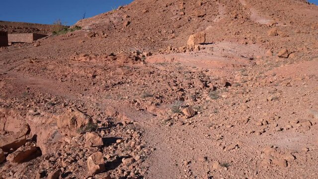POV, Walking through an Arid and rocky Landscape in Africa, Reaching a local building - handheld