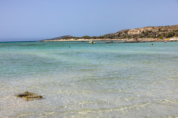  People relaxing on the famous pink coral beach of Elafonisi on Crete, Mediterannean sea, Greece