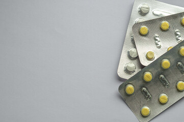 Tablets for colds on a gray background with copy space. Medicines. Means of treatment of diseases.