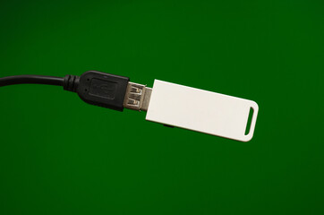 Wi-Fi USB adapter white with a cable on a green background