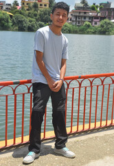 Full length of a Ladakhi young guy posing by lake with looking at camera 