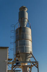 Metal structure warehouse of an industrial carpentry, at sunset on a sunny day