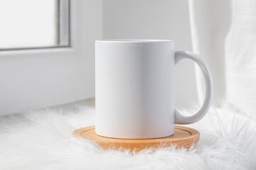 Obraz na płótnie Canvas White ceramic tea cup mockup with winter concept background and copy space for your imprint. Front view 11oz mug background for winter promotional content