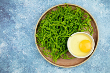 Raw eggs and raw cha-om vegetables leaf for cooking fried eggs cha-om.