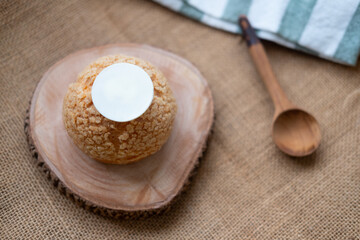 Choux cream placed on a wooden plate