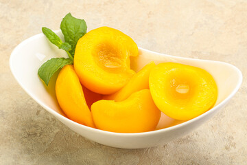 Sweet ripe canned peaches with mint