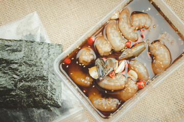 Korean soy sauce pickled shrimp in box serve with seaweed