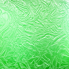Fototapeta na wymiar Shiny green gold texture paper or metal. Green golden foil