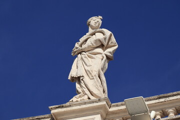 Fototapeta na wymiar St. Peter's Square Colonnade Detail with Statue in Rome, Italy