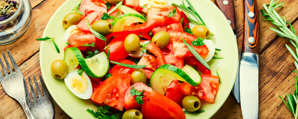 Salad with vegetables, olives, eggs and rosemary