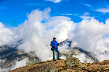 
Drone operator in snow Alps mountain range
