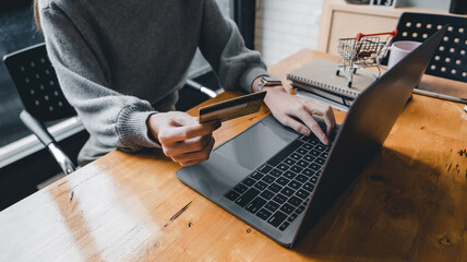 Close up young asian woman holding credit card and using tablet computer. Businesswoman working at home. Online shopping, e-commerce, internet banking, spending money, working from home concept