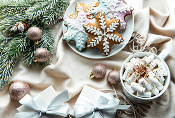 Christmas background with gift box, cocoa and gingerbread cookies.