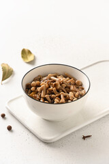 Pickled homemade honey mushrooms in white bowl on a white background. Close up. Vertical format.