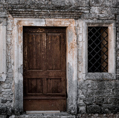 Fototapeta na wymiar Old brown door and stone wall in Istria
