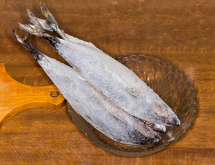 Frozen mackerel in icy glaze in the glass bowl