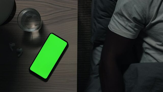 Mobile With Green Screen On Table While Man Falling Asleep