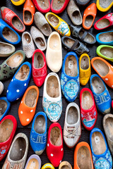 Background of Popular souvenirs - Old wooden Dutch shoes - klomps. A lot of colorful old clomps...