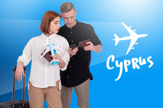Cyprus logo next to travelers. They are going to fly to Cyprus by plane. Man and woman with air tickets to Cyprus. Concept - sale of tour vouchers in the Mediterranean. Cypriot Travelers