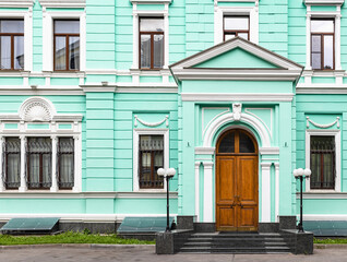 Fototapeta na wymiar facade of green mansion on Spiridonovka Street in Moscow city. House was built in 1902, renovated in 1999