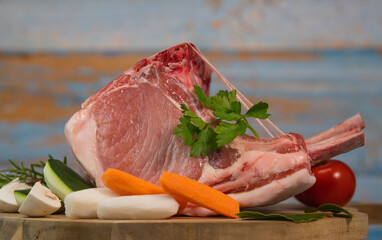 Pork ribs, Pork ribs with raw bone, Entrecote, Fresh and raw meats. Organic food, Meat with spices: pepper, salt, bay leaf, rosemary and its vegetables. High quality photo