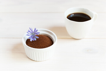 Chicory in a bowl and mug on a wooden table.