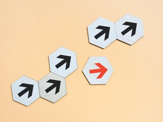 Business disruption and different thinking idea concept. Wooden hexagon with arrows symbol.