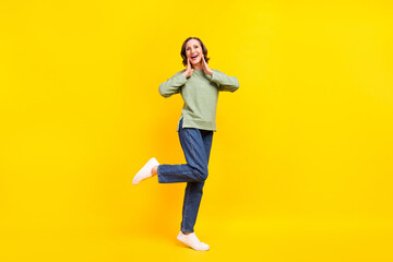 Full length body size view of attractive cheerful woman enjoying having fun good mood isolated over vivid yellow color background