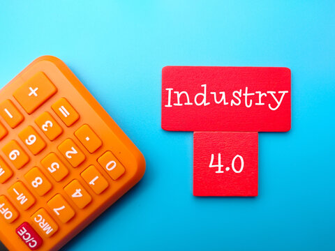 Calculator and colored cube written with text Industry 4.0 on blue background. - Powered by Adobe