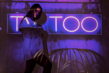 silhouette of a young beautiful woman on the background of neon projector inscriptions, slight blur