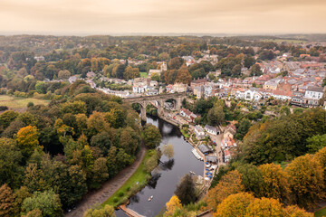 Fototapeta na wymiar Aerial drone photo of the beautiful village of Knaresborough in North Yorkshire in the winter time showing the famous Knaresborough Viaduct and train tracks and the River Nidd