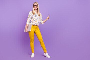 Photo of sweet cute mature lady dressed print blouse glasses holding modern gadget pointing empty space isolated purple color background