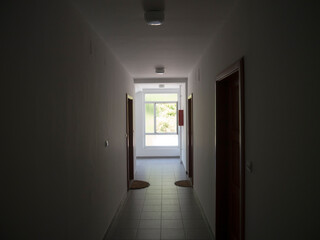 Residential house corridor window with white plastic frame front view from inside