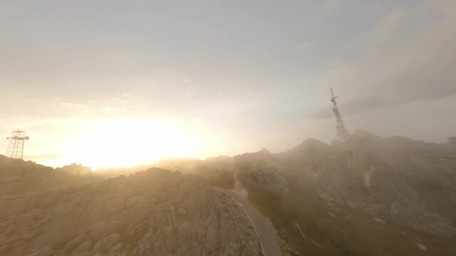 FPV video, mountain surfing, flying at high speed in the clouds with a granitic mountain range and an antenna farm during a beautiful sunrise. Mount Limbara (Monte Limbara) Tempio Pausania, Sardinia, 
