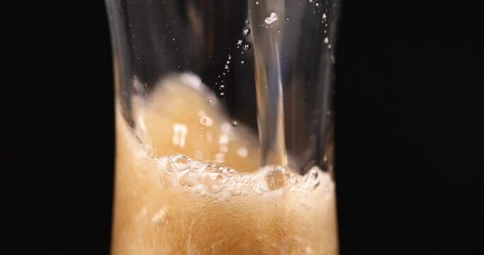 Foamy drink is poured into transparent glass beaker 4k movie