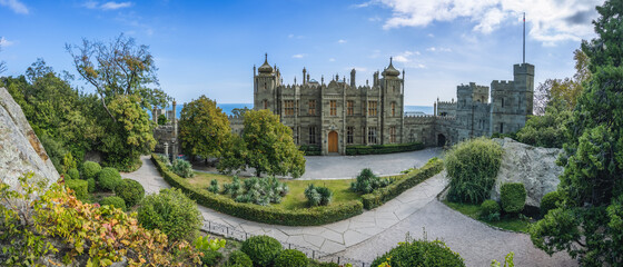 Vorontsov Palace in Alupka, Crimea. Panoramic view of castle with blue sky background. Yucca bushes...