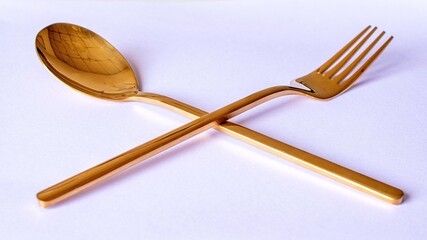 Elegant elegant golden cutlery isolated on white background.