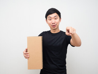 Man holding parcel box and point finger at you